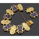 An Egyptian revival style yellow metal and enamel scarab bracelet