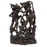 A 20th century Balinese hardwood carving depicting monkeys engaged in battle,