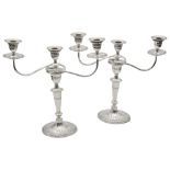 A pair of George V silver neo-classical design three light candelabra