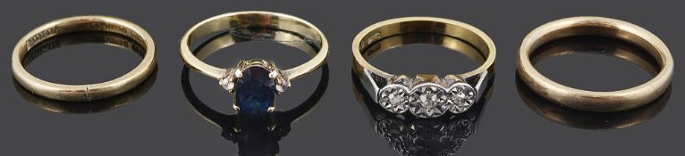 A sapphire and diamond ring and three other rings