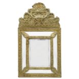 A 19th century Flemish embossed brass cushion wall mirror in 17th century style