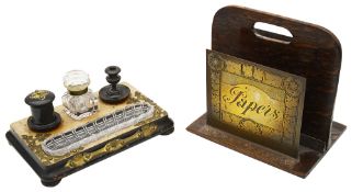 A Victorian ebonised inkstand and a twentieth century brass and oak paper rack