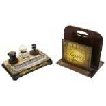 A Victorian ebonised inkstand and a twentieth century brass and oak paper rack