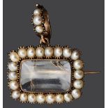 A Georgian half pearl framed memorial locket/brooch