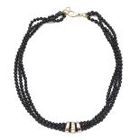 A contemporary onyx bead and diamond necklace