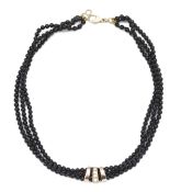 A contemporary onyx bead and diamond necklace