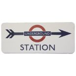 A London Underground enamel direction sign displaying 'UNDERGROUND / STATION',blue lettering on