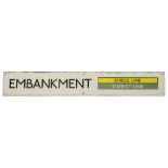 A London Underground enamel station sign for Embankment,with black lettering on a white ground and a