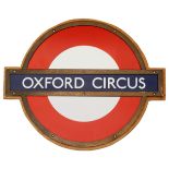 A London Underground Oxford Circus enamel 'bullseye' roundel sign,in bronze frame and mounted on