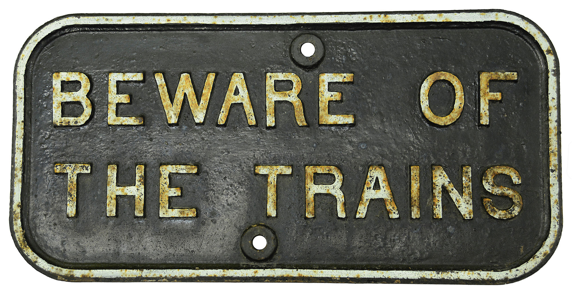 A cast iron notice displaying 'BEWARE OF THE TRAINS'