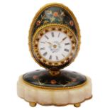 An early 20th c. green enamel gilt metal egg shaped boudoir timepiece