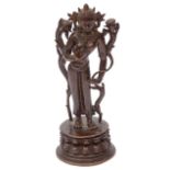 A Tibetan or Himalayan patinated bronze figure of Tara