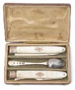 A Georgian silver and mother of pearl folding knife and fork and silver spoon travelling set