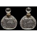 A pair of George V silver mounted cut glass scent bottles,