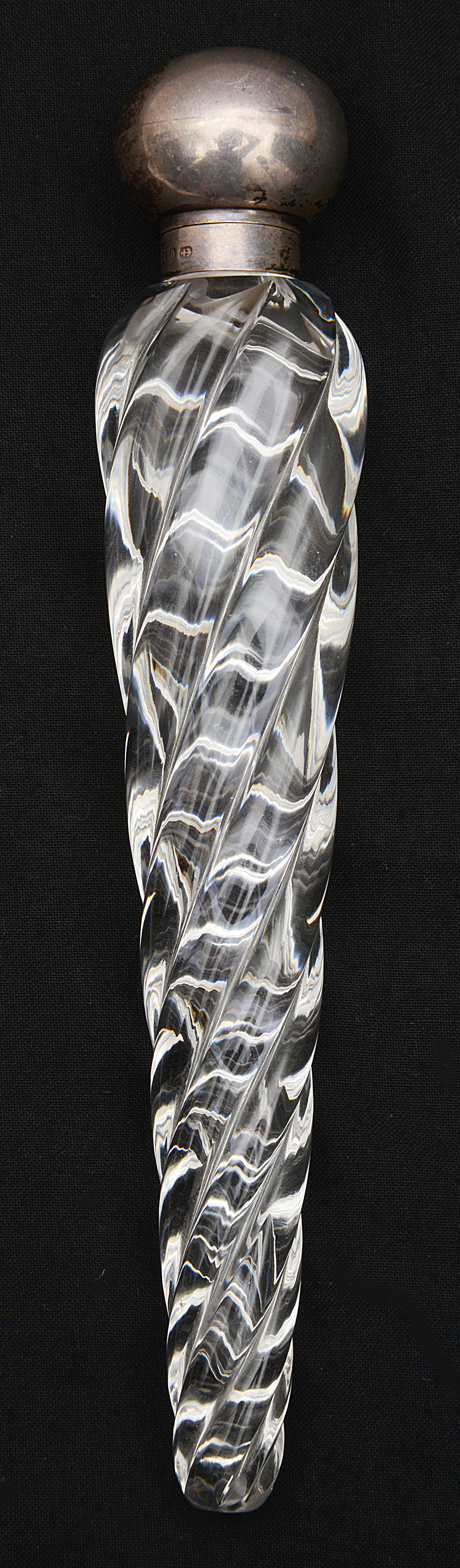 A late Victorian silver mounted clear glass torpedo shaped scent bottle