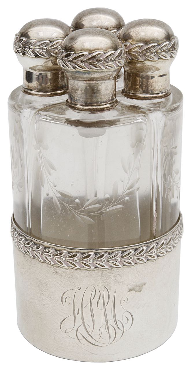 A late 19th c. Fr. silver and engraved glass four bottle perfume set