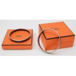 Two Hermes boxed enamel and palladium bangles