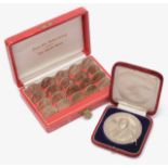 An Austrian cased set of 25 schilling coins and a cased .950 silver prize medal