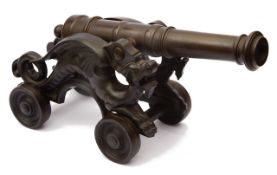 A late 19th century patinated bronze table cannon
