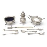 An Edwardian silver three piece cruet set and other silver items