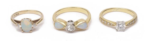 A single stone diamond set ring and two opal and diamond set rings