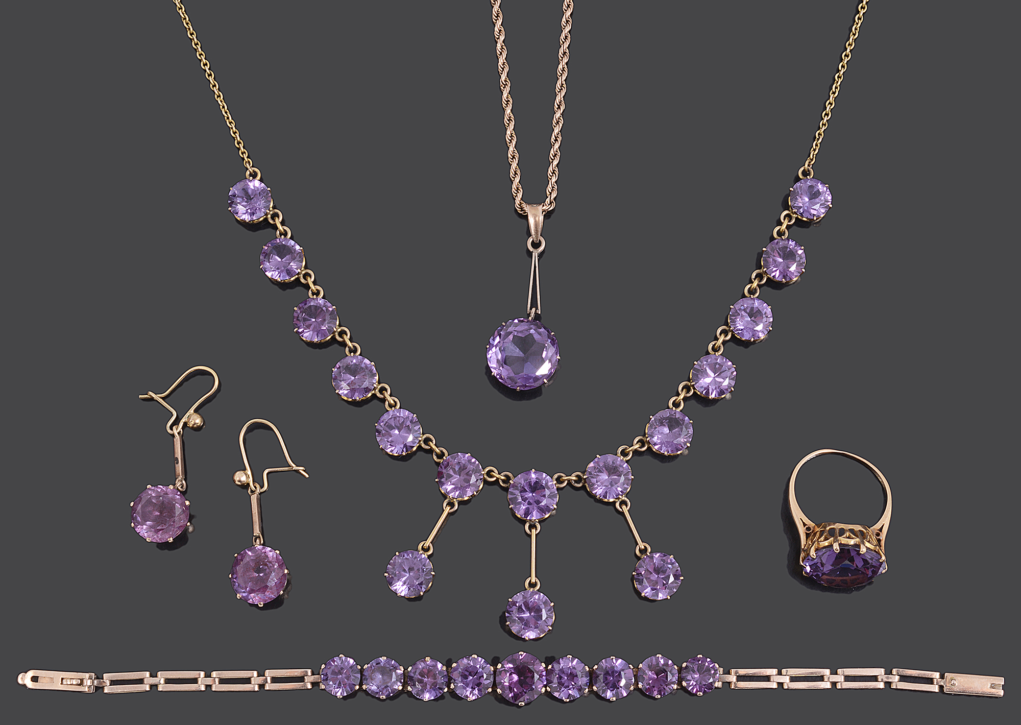 An Edwardian amethyst set drop necklace and a matched suite of similar jewellery