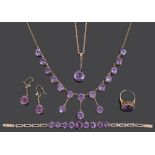 An Edwardian amethyst set drop necklace and a matched suite of similar jewellery