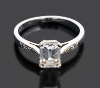 A single stone emerald cut diamond set ring