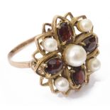 A yellow metal garnet and pearl dress ring