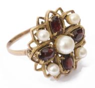 A yellow metal garnet and pearl dress ring