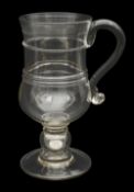 A large 19th century glass coin tankard