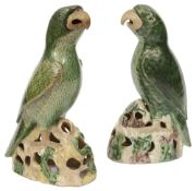 A matched pair Chinese export famille verte biscuit models of parrots