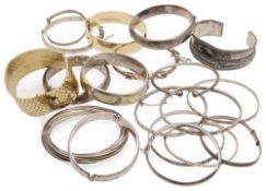A collection of seventeen silver and white metal bracelets and bangles, 20th century