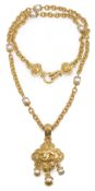 A vintage Chanel simulated pearl and gold tone pendant and chain,