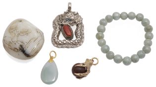 A contemporary carved jade boulder pendant and other items