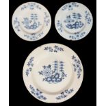 A mid 18th century English Delft charger and a matching pair of plates c.1760