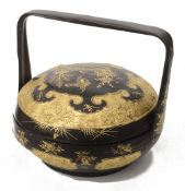 A South East Asian Chinese gold decorated black lacquer wedding basket and cover