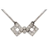 A stylised diamond-set bow pendant