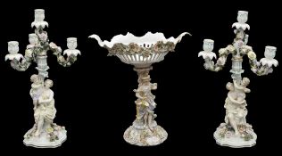 A pair of late 19th century Sitzendorf porcelain flower encrusted figural four light candelabra