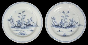 A near pair of mid 18th century English Delft chargers