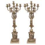 A pair of French Empire style silver plated figural five light candelabra