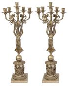 A pair of French Empire style silver plated figural five light candelabra