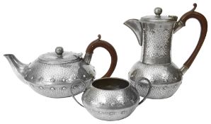 An Arts and Crafts pewter three piece tea service