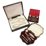 A modern cased silver four piece dressing table set and two cased silver mounted manicure sets