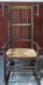 Late 19th / early 20th century rush seated oak bobbin decorated rocking chair. Approx. 107cms H x