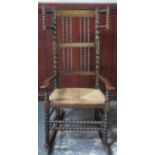 Late 19th / early 20th century rush seated oak bobbin decorated rocking chair. Approx. 107cms H x