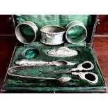 PAIR OF SILVER NAPKIN RINGS PLUS ANOTHER, PAIR OF PLATED SUGAR TONGS AND PART MANICURE SET IN BOX,