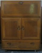 Ercol mid 20th century oak fall front writing cabinet, with fitted interior. Approx. 110cms H x