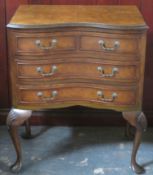 20th century walnut veneered serpentine fronted chest of four drawers, on cabriole supports. Approx.