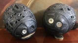 TWO HIGHLY PIERCED DECORATED AFRICAN(?) CARVED NUT MONEY BOXES